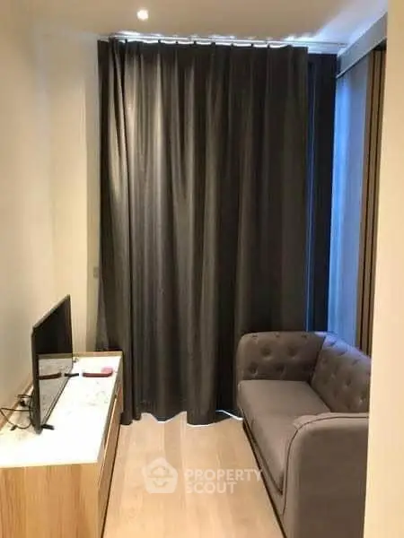 Cozy small living room with modern sofa and TV setup, ideal for compact urban living.