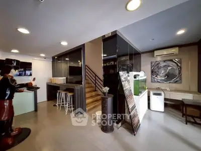 Modern interior with sleek design, featuring a staircase and stylish decor elements.