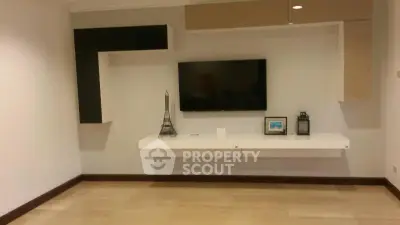 Modern living room with wall-mounted TV and stylish shelving
