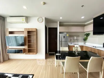 Modern open-layout kitchen and living area with sleek furniture and appliances