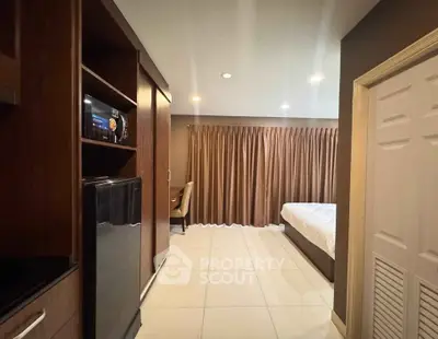 Spacious bedroom with modern amenities and elegant decor