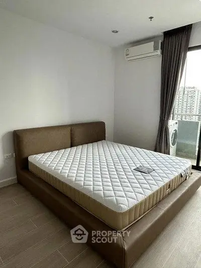 Modern bedroom with large bed and balcony view in a stylish apartment
