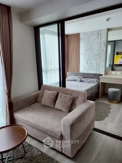 Modern studio apartment with cozy living area and stylish bedroom