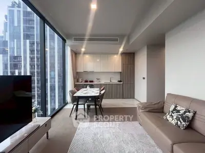 Modern living room with city view, open kitchen layout, and stylish decor.