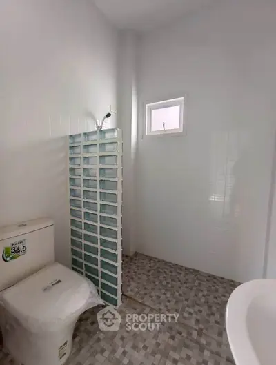 Modern bathroom with glass block shower and tiled floor