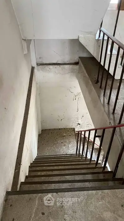 Explore this spacious stairwell in a well-maintained building, perfect for easy access and movement.