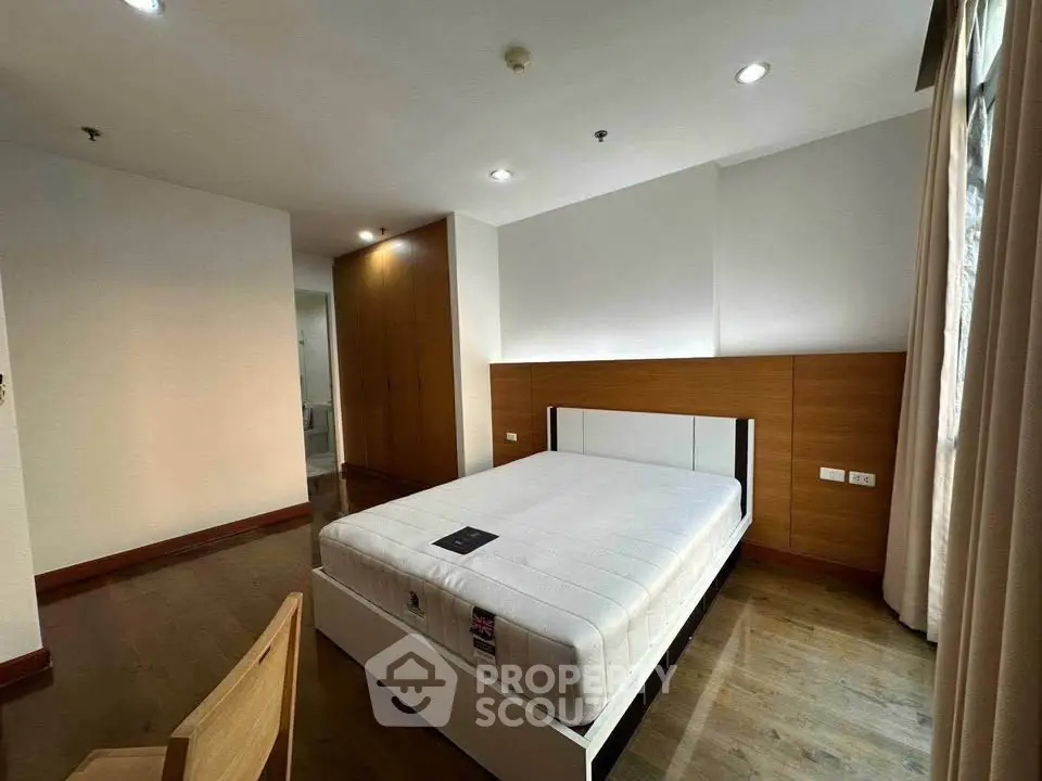 Spacious bedroom with modern design and ample natural light in a stylish apartment.