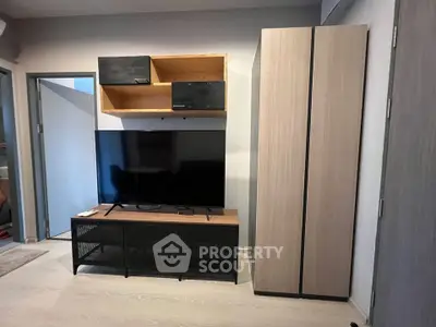 Modern living room with sleek TV stand and storage cabinets, perfect for contemporary urban living.