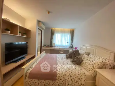 Cozy bedroom with stylish decor and natural light, featuring a comfortable bed and modern TV setup.
