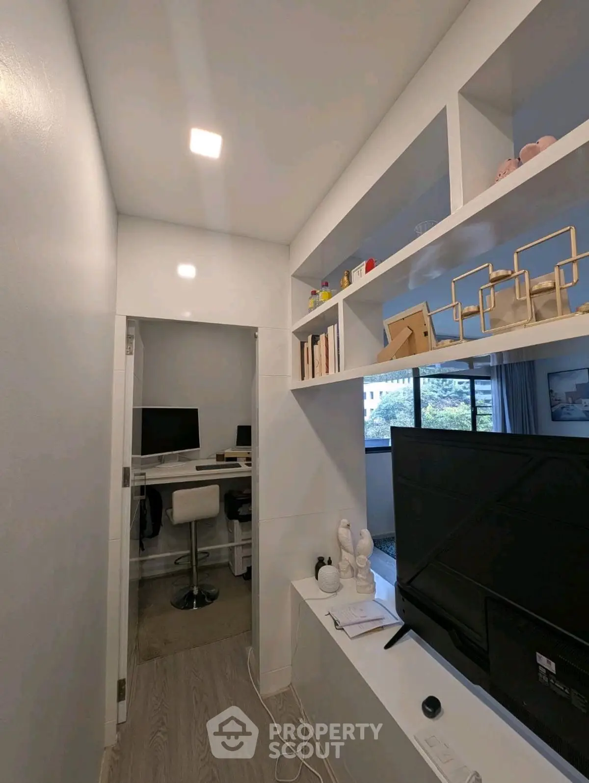Modern study room with built-in shelves and computer desk, perfect for productivity.