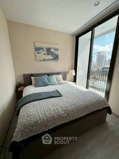 Modern bedroom with large window and city view, featuring cozy bed and stylish decor.