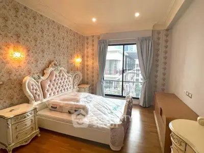 Luxurious bedroom with elegant decor and large window offering city view