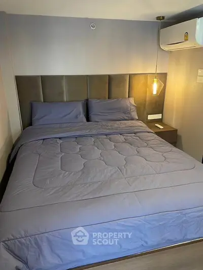 Cozy bedroom with modern decor and plush bedding in a stylish apartment.