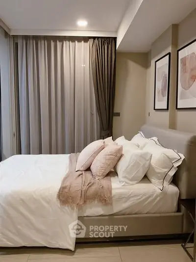 Elegant bedroom with modern decor and cozy ambiance, featuring stylish artwork and soft lighting.