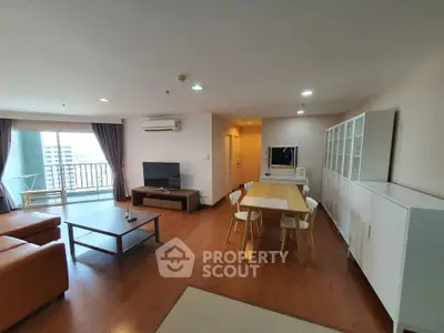 Spacious modern living room with balcony and stylish furniture in a high-rise apartment.