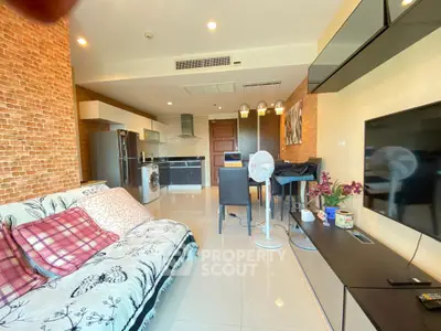 Modern open-plan living room with kitchen, featuring stylish decor and contemporary appliances.