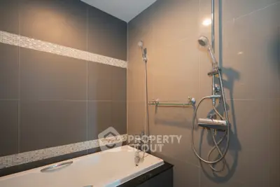 Modern bathroom with sleek design and bathtub in contemporary apartment.