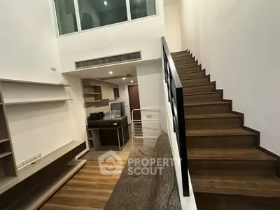 Modern duplex interior with wooden staircase and open kitchen layout