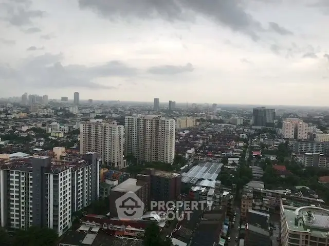Stunning cityscape view from high-rise building showcasing urban skyline and residential towers.