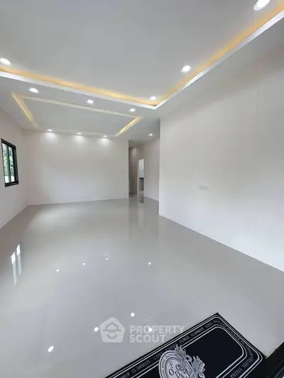 Spacious modern living room with recessed lighting and glossy tile flooring.