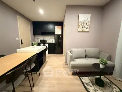 Modern open-plan living room with sleek kitchen and cozy seating area.