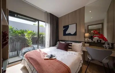 Stylish bedroom with modern decor and balcony view, perfect for relaxation.