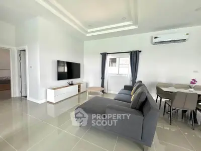 Spacious modern living room with sleek furniture and natural light
