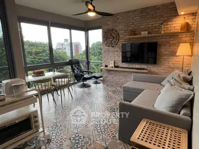 Charming living room with large windows, stylish decor, and scenic views, perfect for relaxation and entertaining.