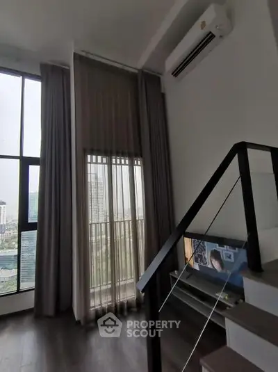 Modern high-rise apartment with floor-to-ceiling windows and stylish interior design.
