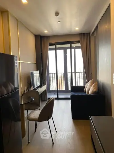 Modern living room with balcony view, sleek furniture, and natural light in a stylish apartment.