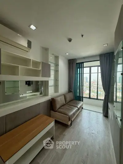 Modern living room with sleek design and city view from large window.