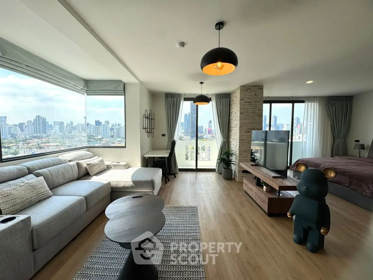 Modern open-plan living room with city view and stylish decor