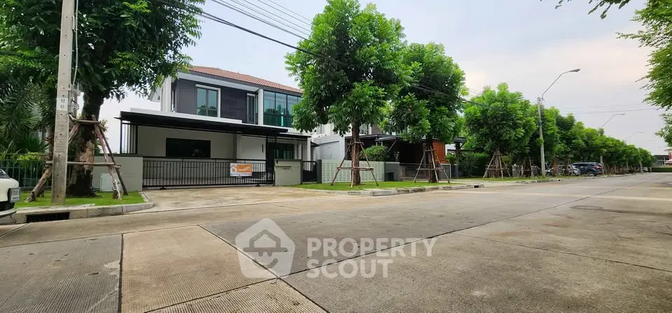 Modern suburban house with lush greenery and spacious driveway