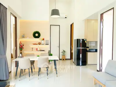 Modern living room with dining area, stylish decor, and open kitchen layout.