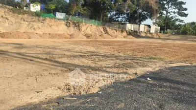 Vacant land plot ready for development with clear terrain and surrounding greenery.
