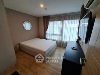 Modern bedroom with large window and stylish decor