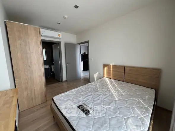 Spacious bedroom with wooden furniture and natural light