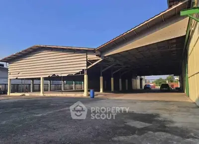 Spacious industrial warehouse with ample parking and open layout, ideal for storage or commercial use.