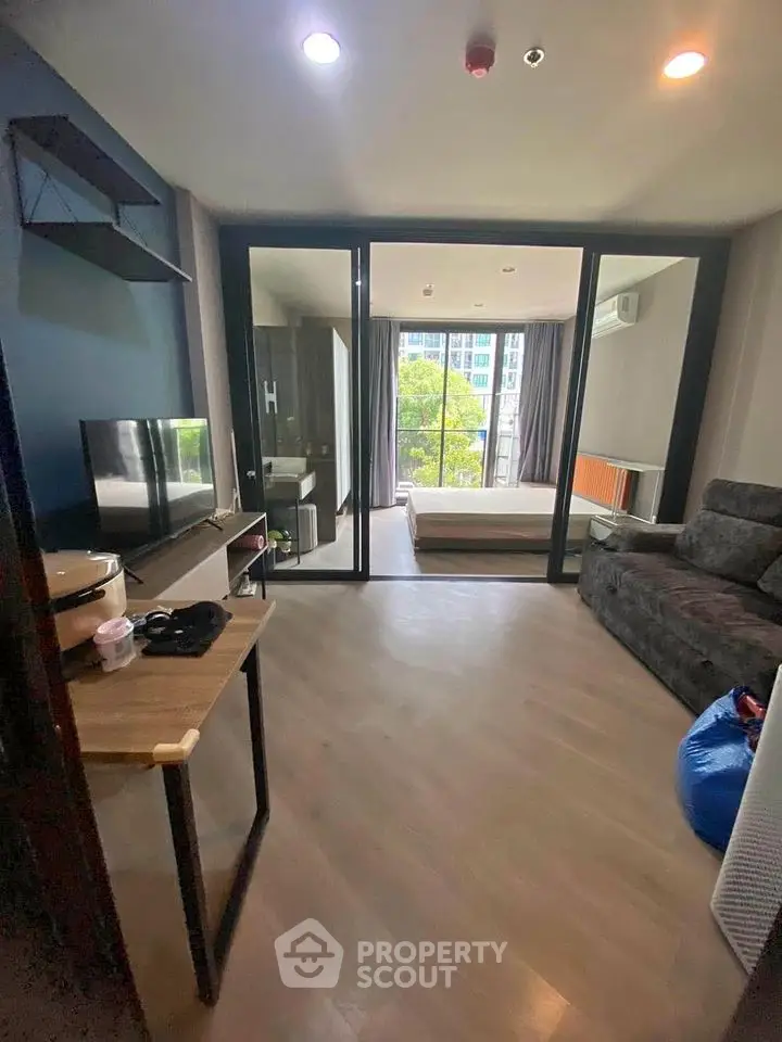 Modern studio apartment with open layout and large windows