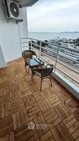 Stunning balcony with ocean view and stylish wooden flooring, perfect for relaxation.