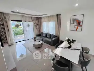 Modern living room with elegant dining area and large windows for natural light.
