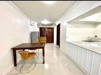 Modern kitchen and dining area with sleek design and open layout in a stylish apartment.