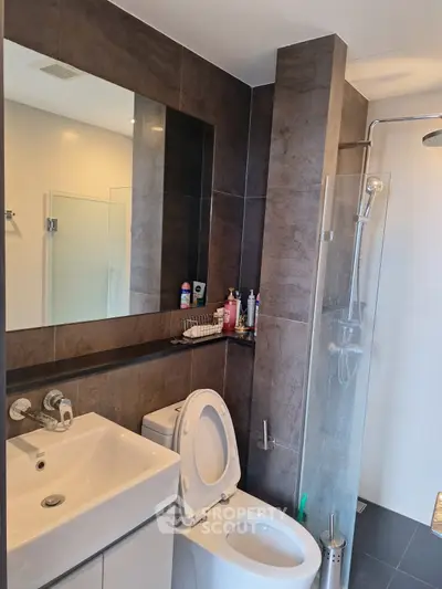 Modern bathroom with sleek fixtures and glass shower enclosure