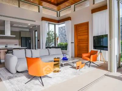 Luxurious modern living room with stylish furniture and large windows offering natural light.