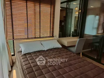 Cozy bedroom with modern decor and large window blinds