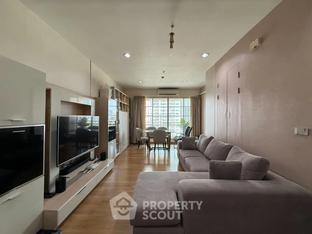 Spacious living room with modern decor and large windows offering natural light.