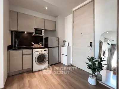 Modern compact kitchen with washing machine and sleek appliances