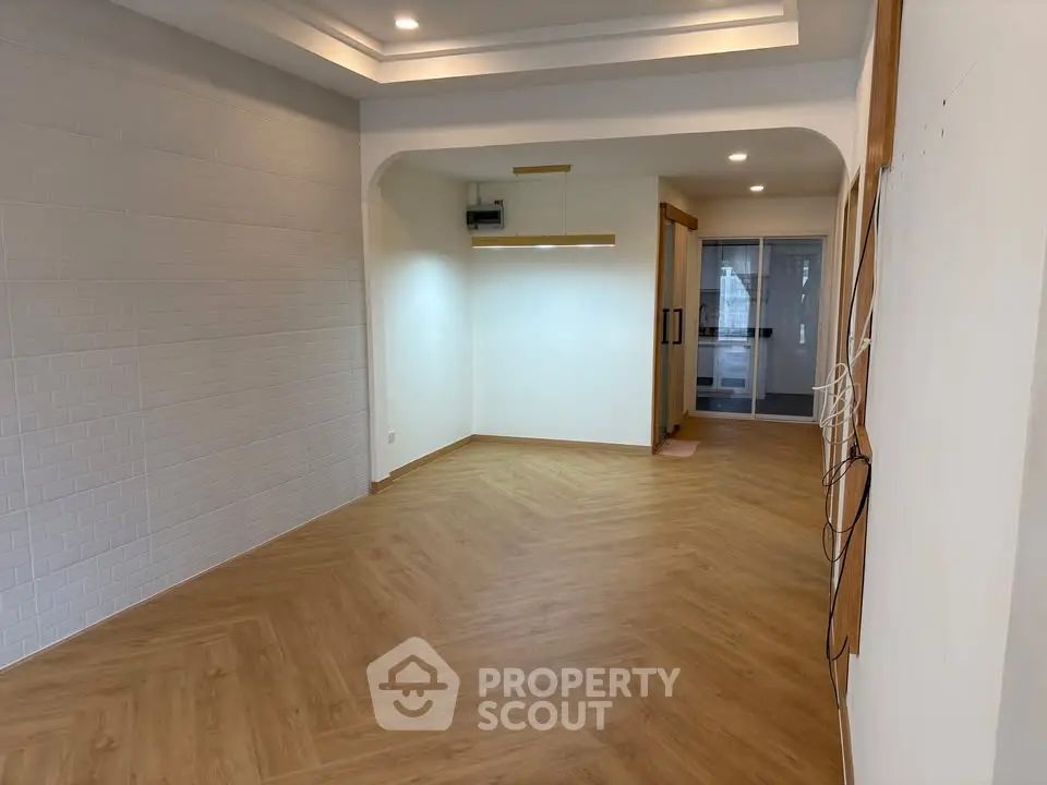 Spacious modern living room with wooden flooring and recessed lighting