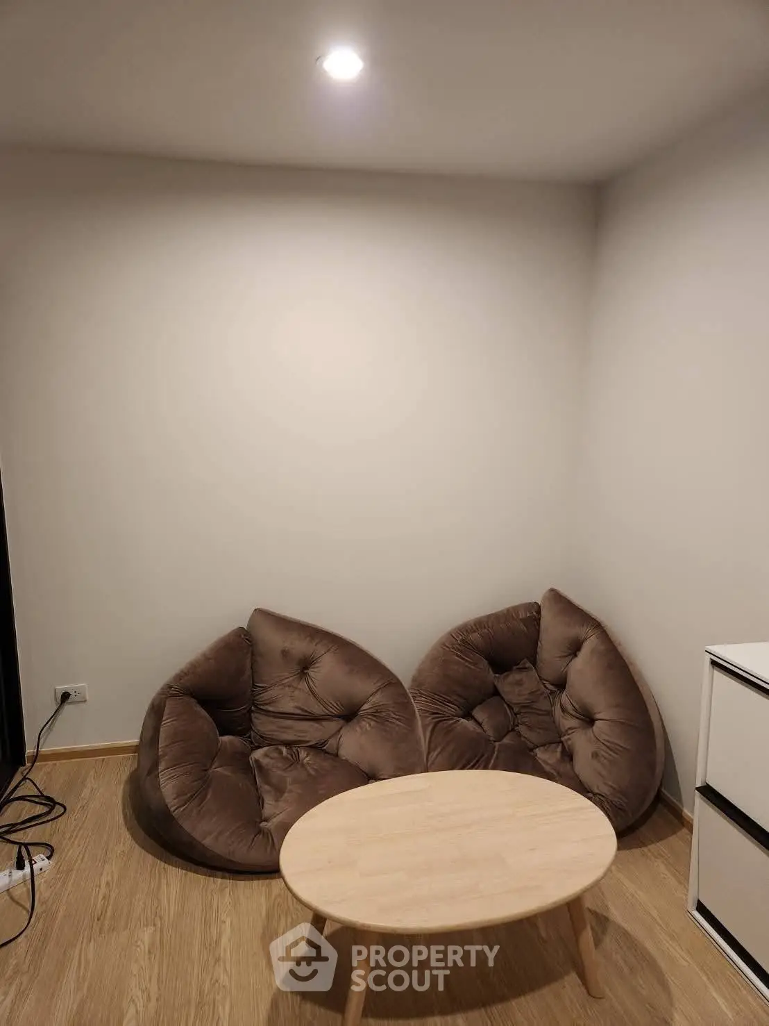 Cozy corner with plush seating and wooden table in modern apartment