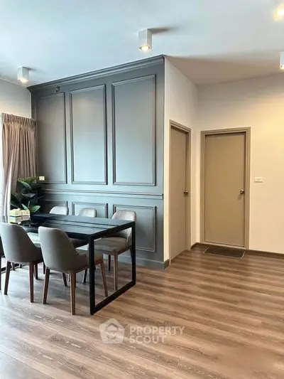 Modern dining area with elegant paneling and sleek furniture